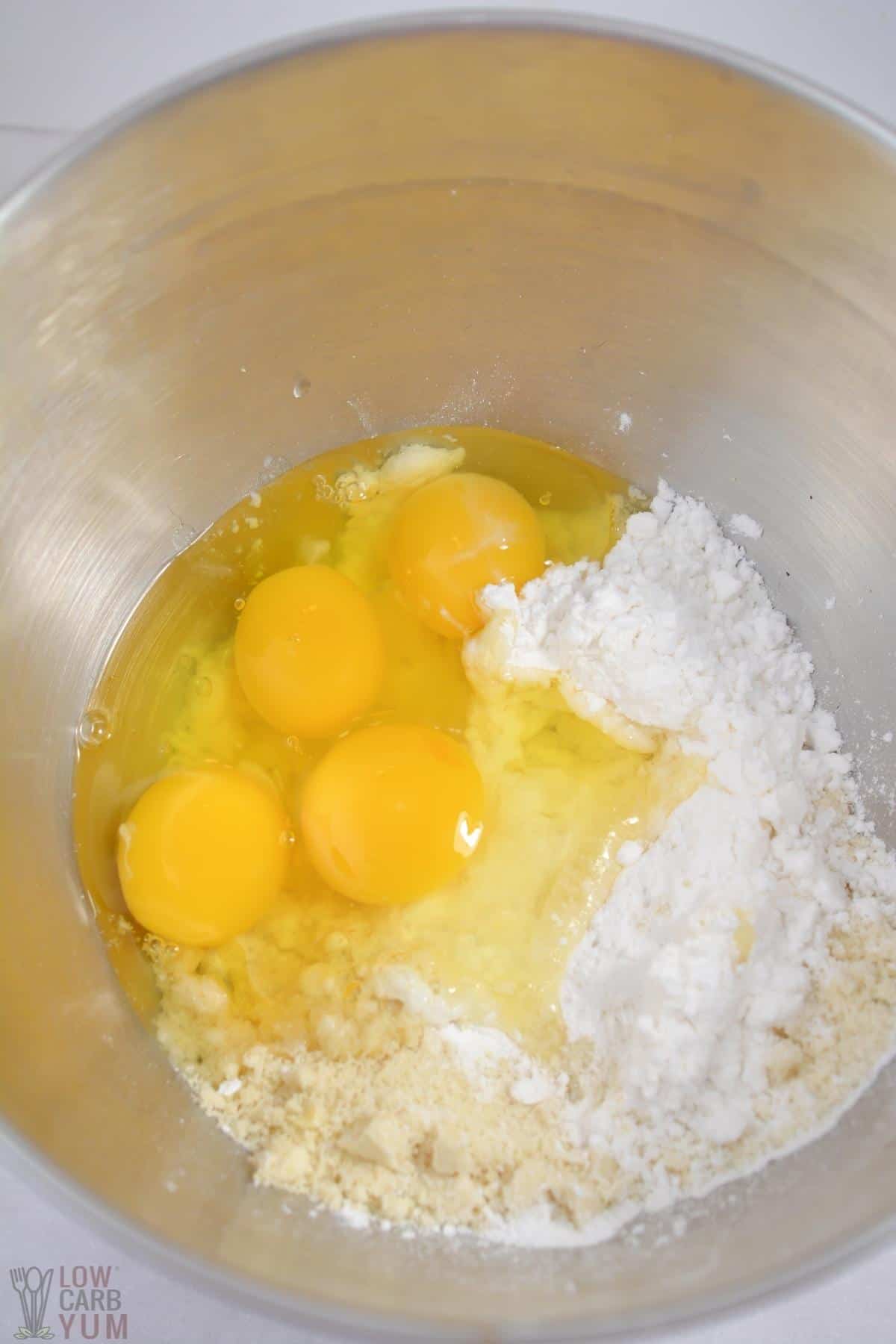 almond flour cake batter ingredients in metal mixing bowl.