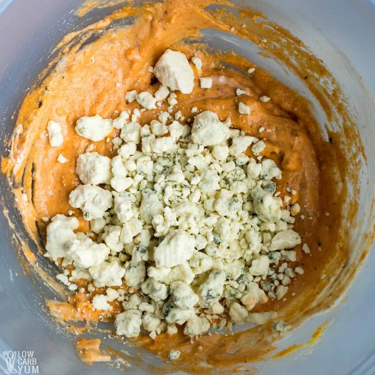 adding blue cheese to seasoned mixture.