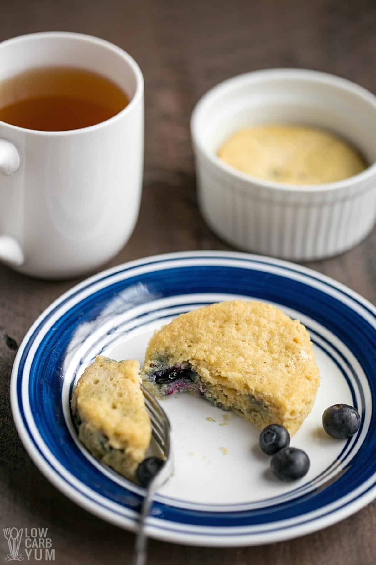 blueberry mug cake with tea sliced in half.