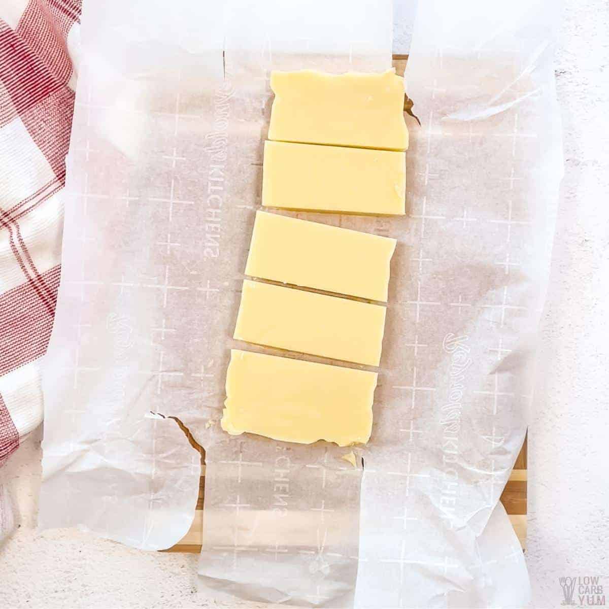 cutting white chocolate fudge after set on parchment paper.