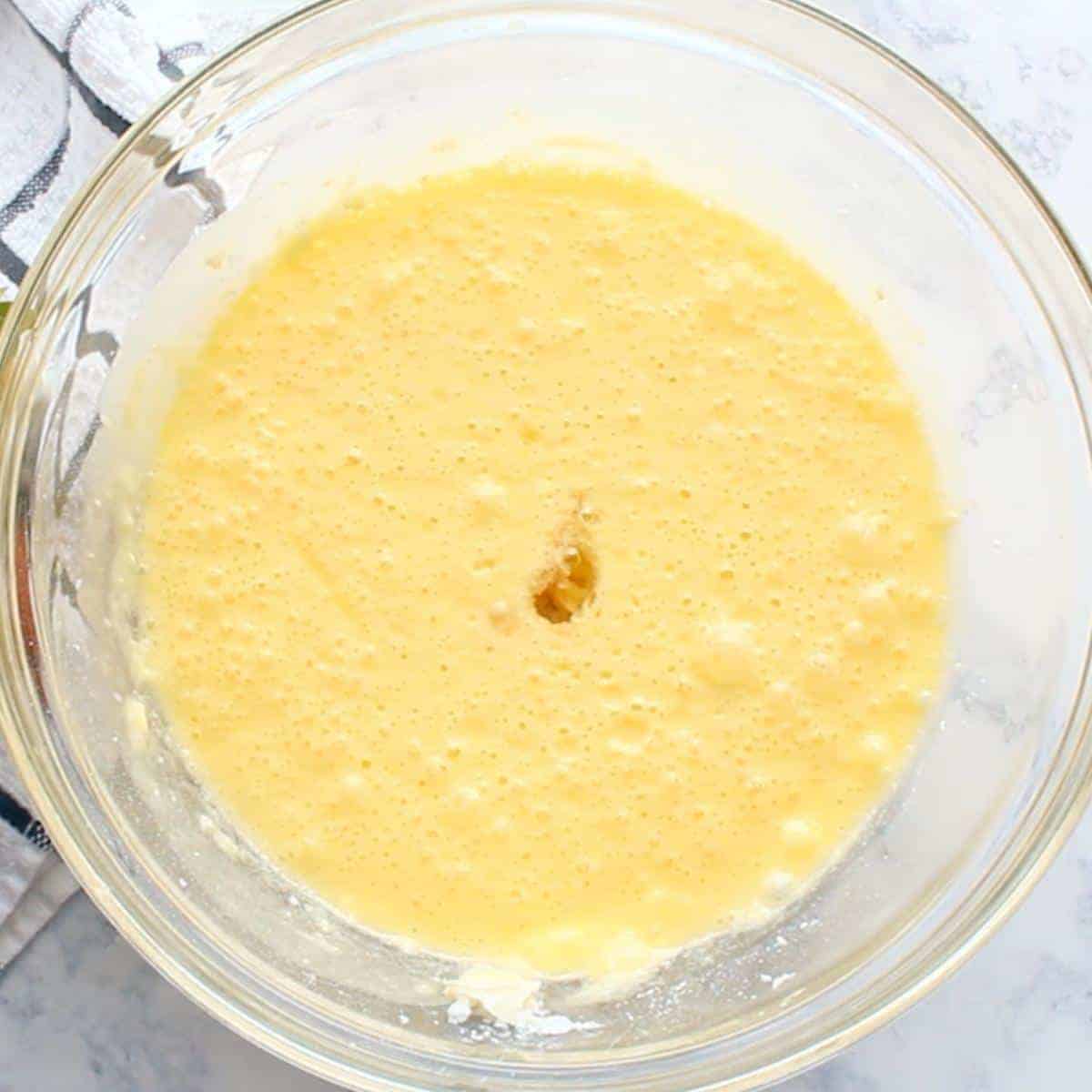 eggs beaten in and extract added to glass mixing bowl.