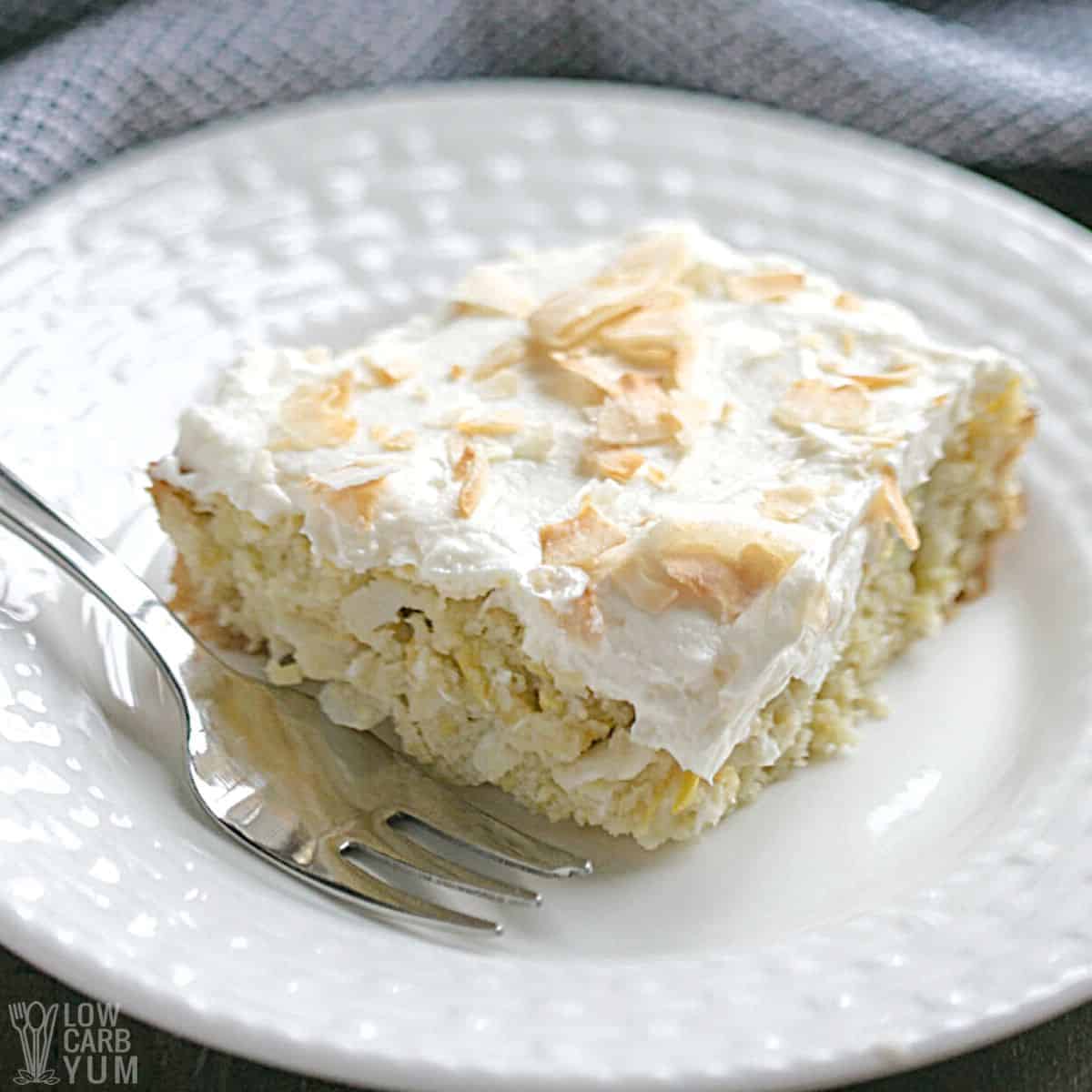 keto coconut cake slice on white plate.