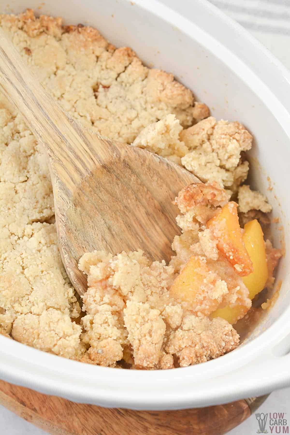 scooping cobbler out of baking dish.