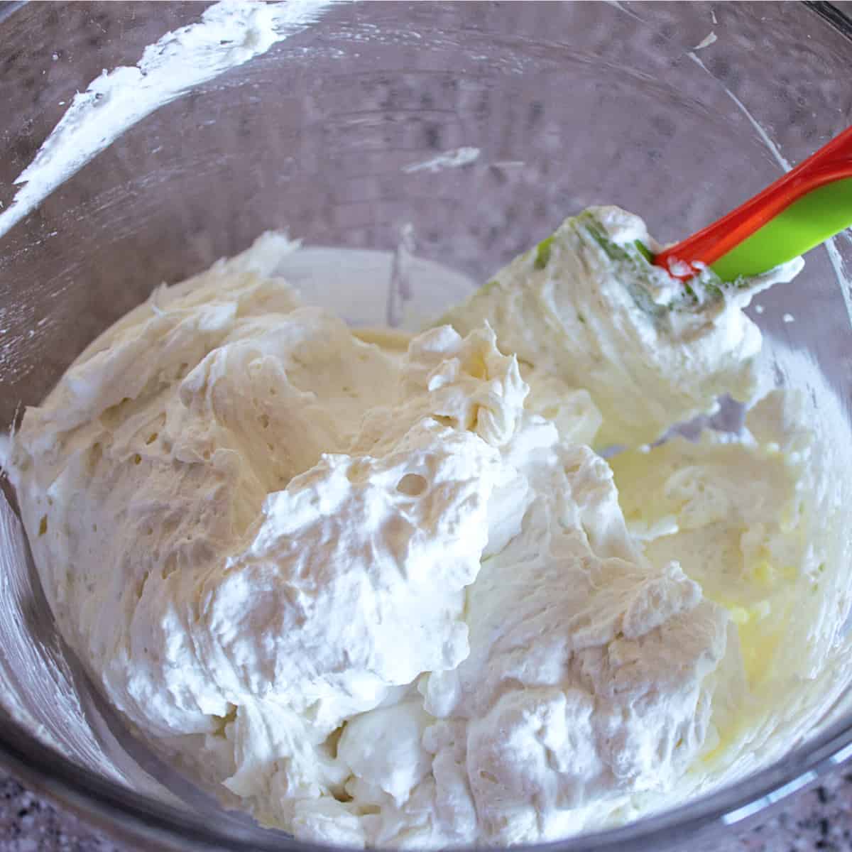 folding in stabilized whipped cream into filling.