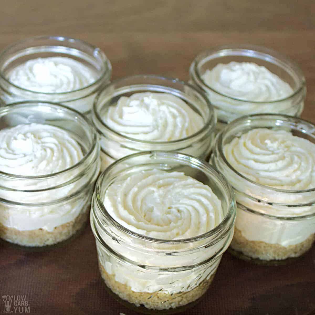 piped no-bake key lime cheesecake filling in jars.