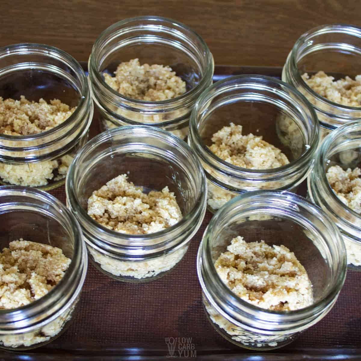 cheesecake no-bake crust added to small mason jars.