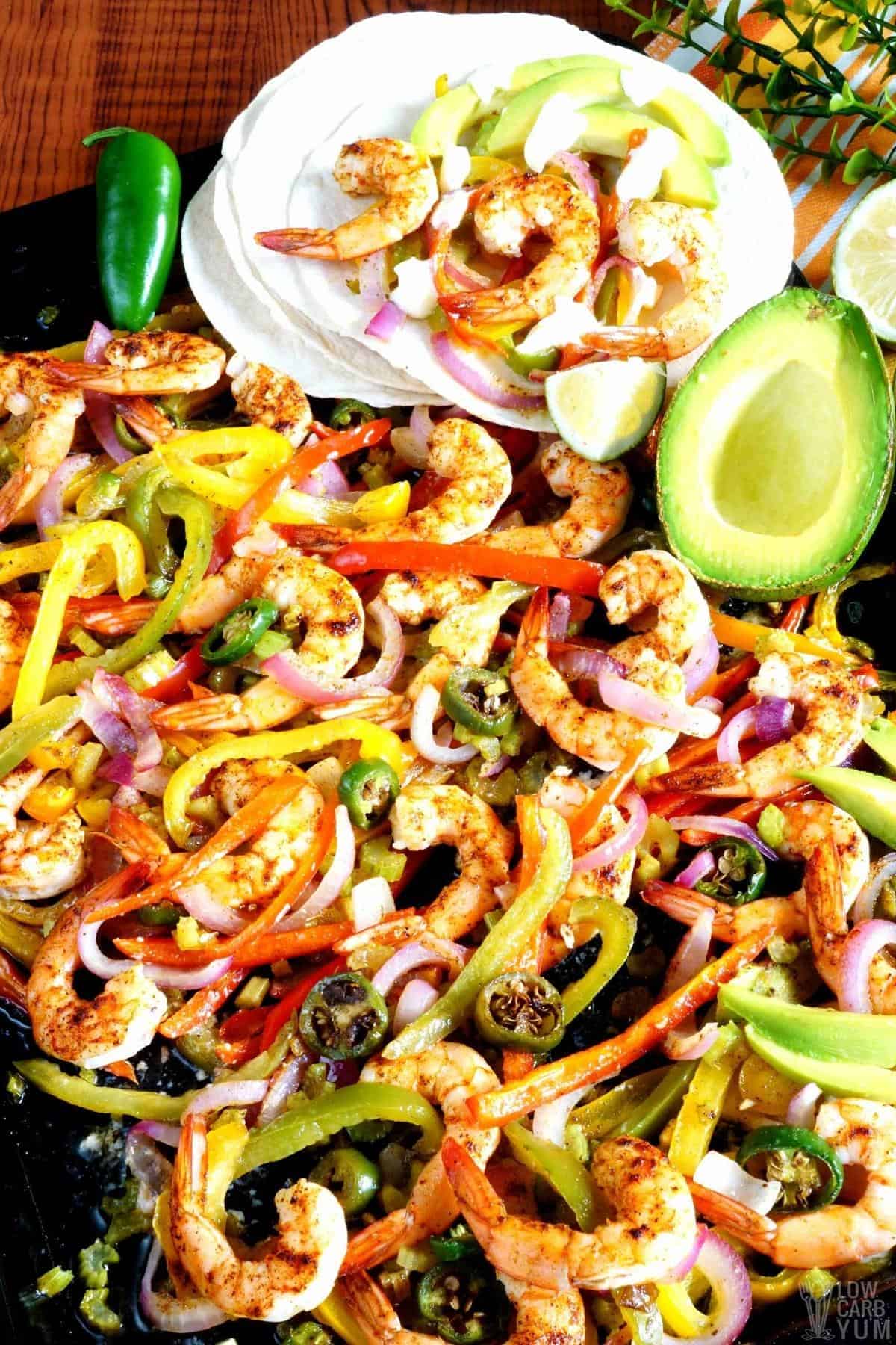 shrimp fajitas made in sheet pan with tortillas.