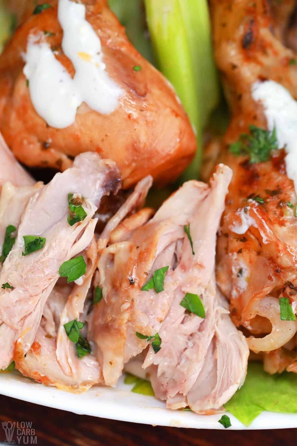 closeup of tender meat on slow cooker buffalo chicken.