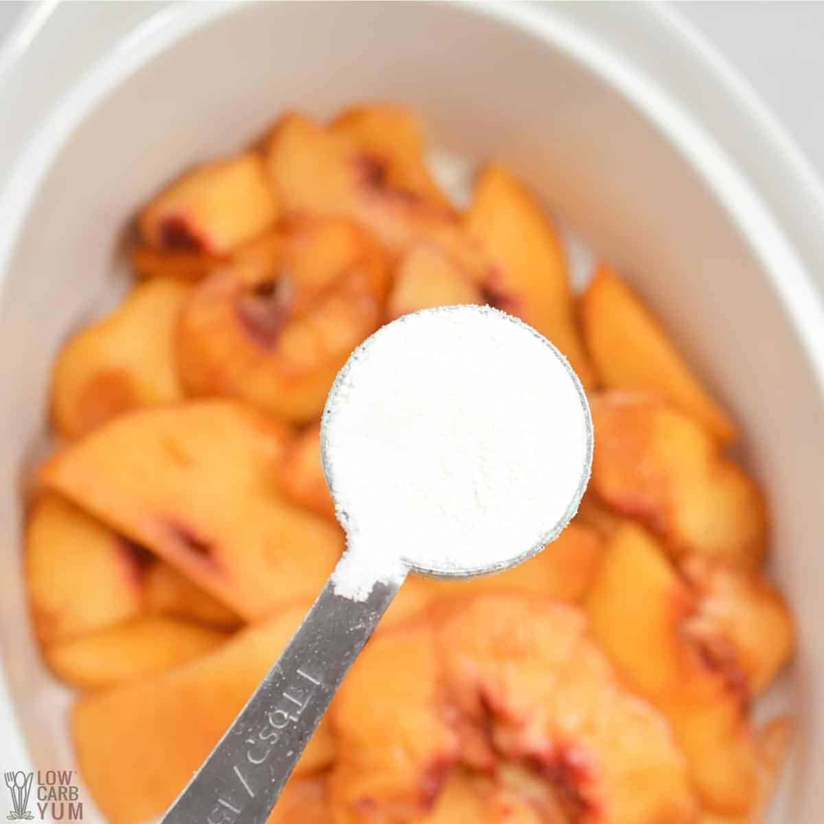 adding sweetener to sliced peaches.