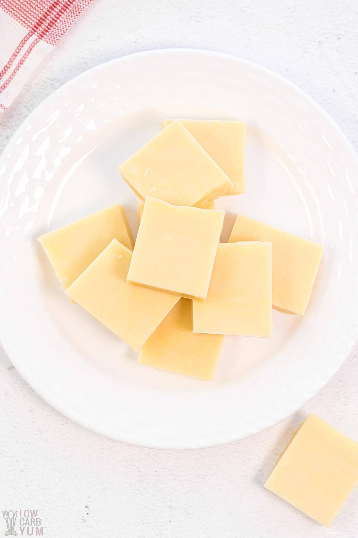 keto friendly fudge squares on white plate overhead shot.