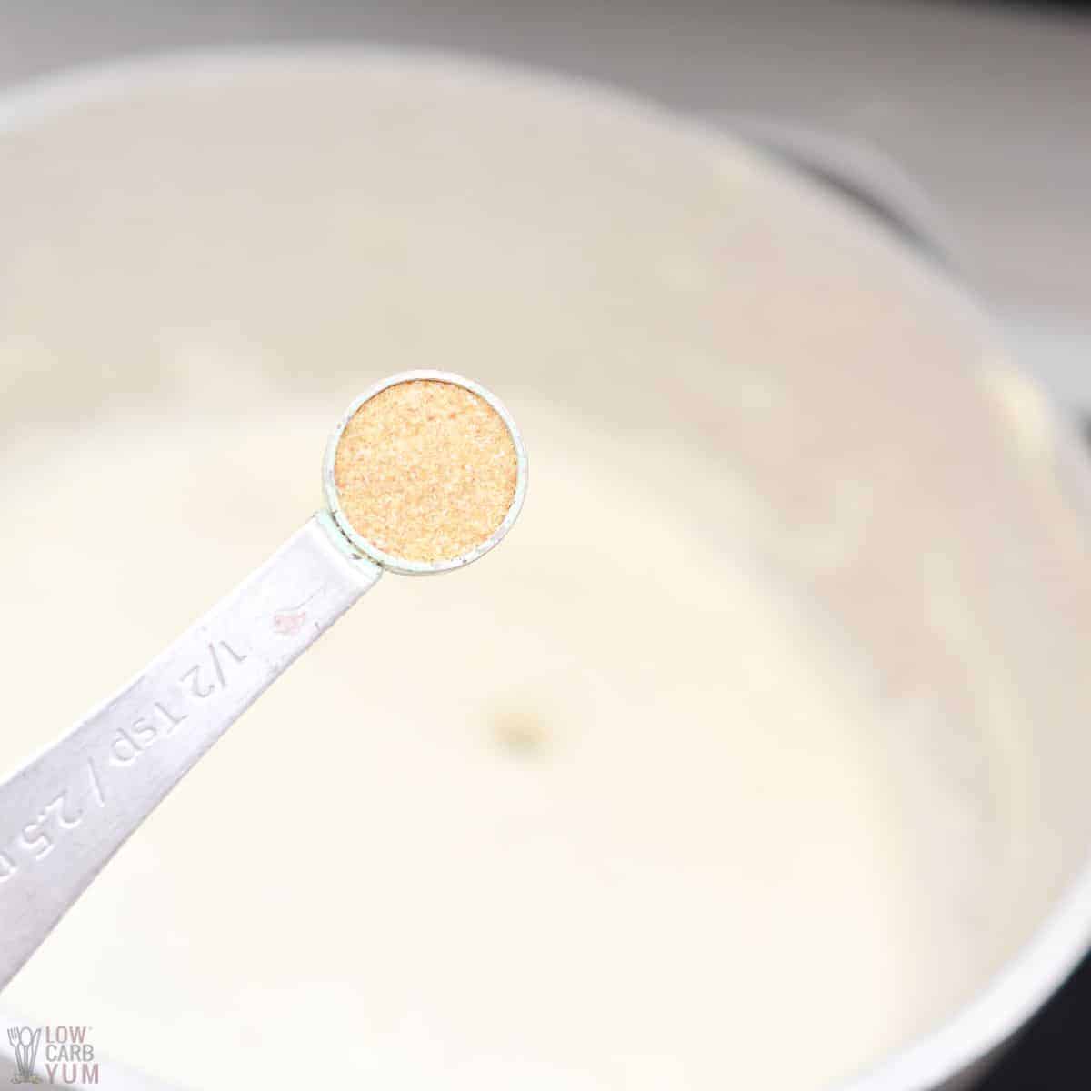 adding garlic powder to the cream sauce.