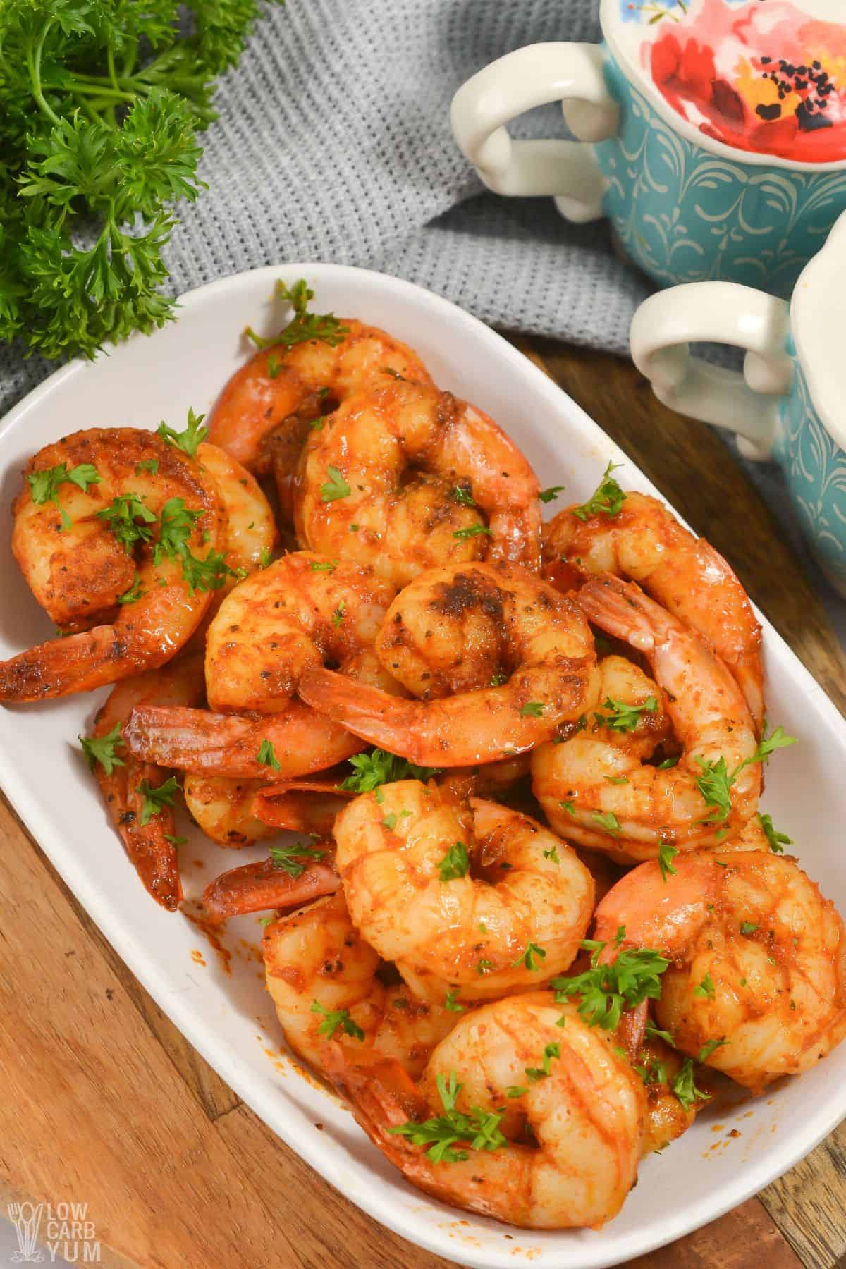 blackened shrimp on serving plate with salt and pepper shakers.