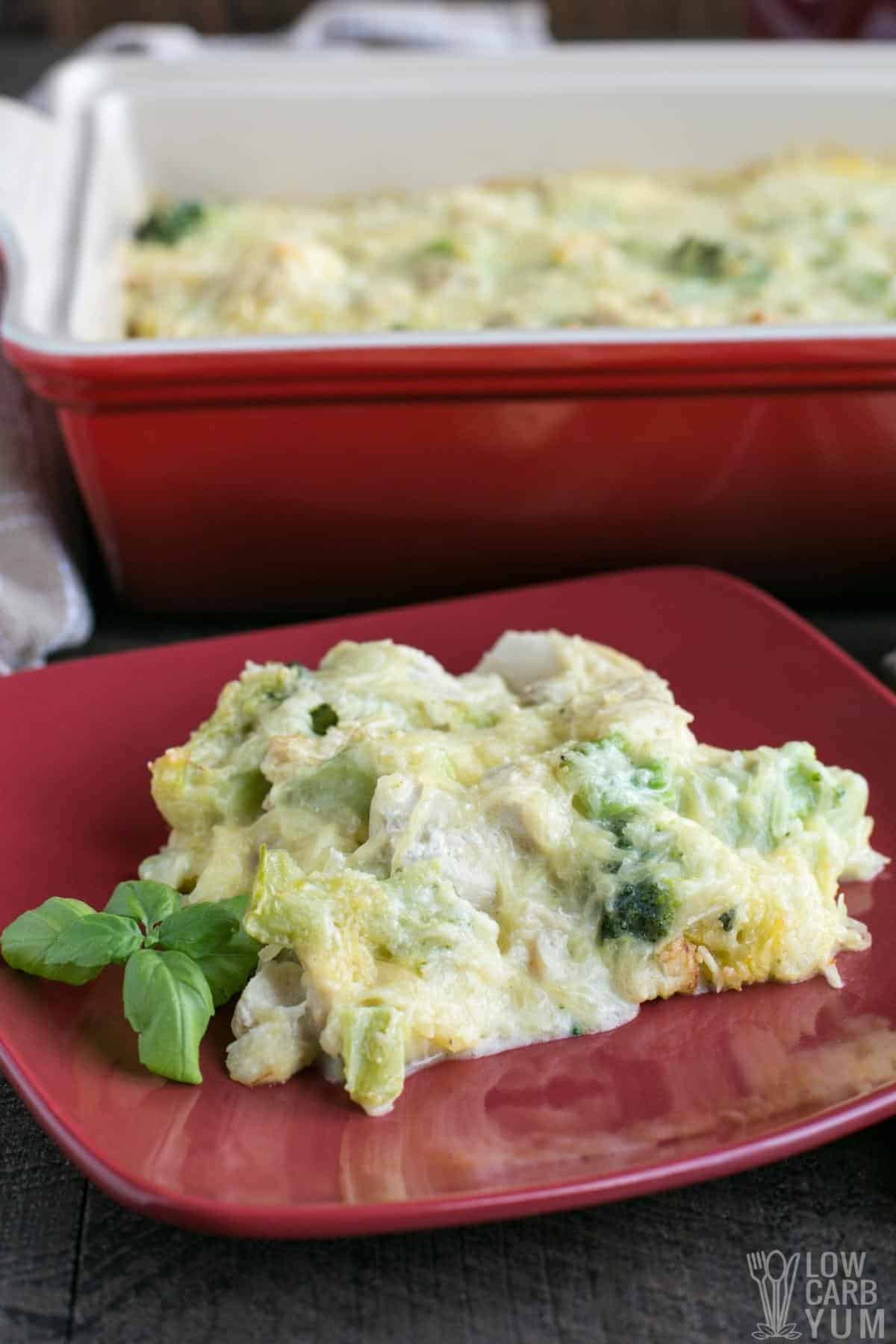 chicken tetrazzini on red plate with casserole in back.