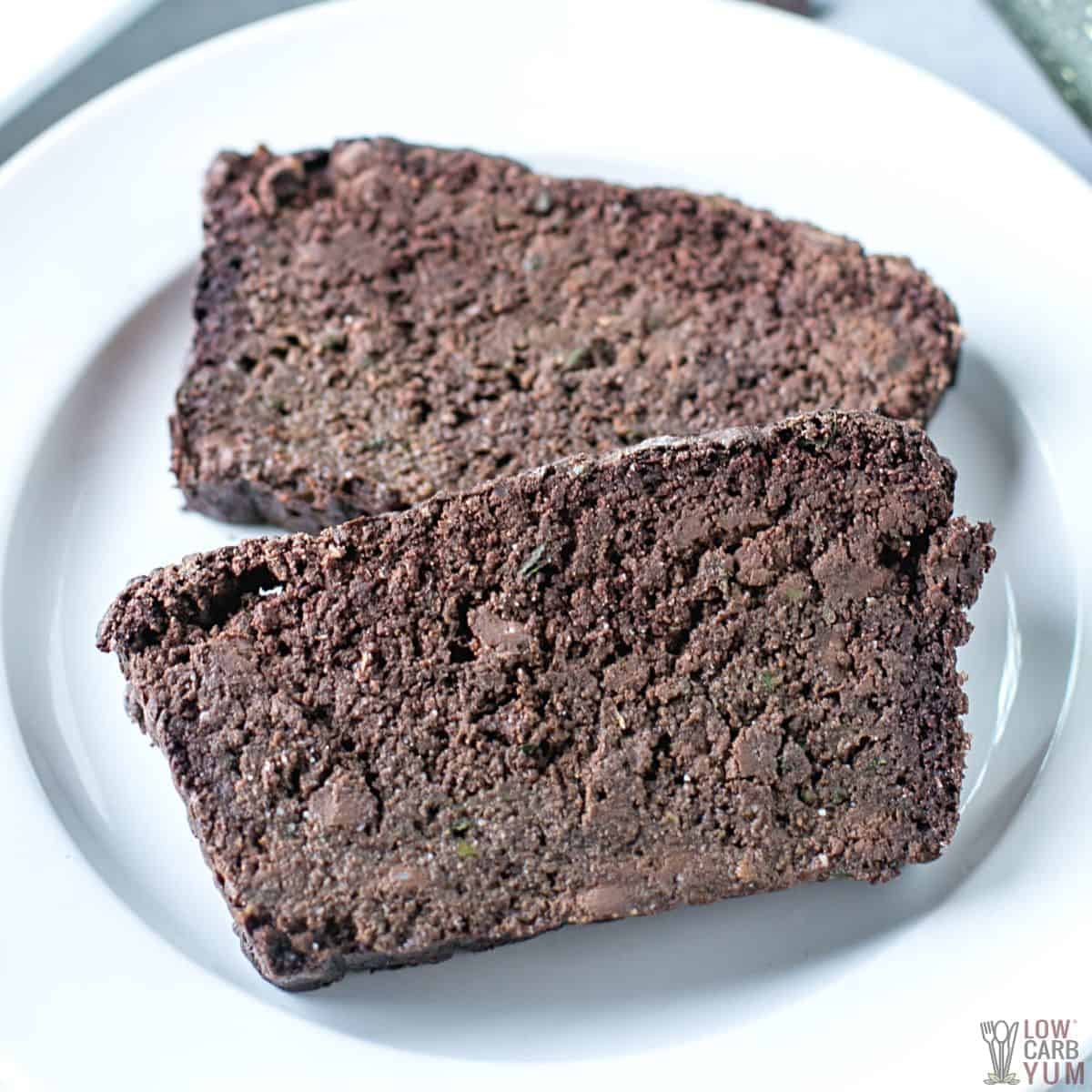 chocolate zucchini bread slices on small white plate.