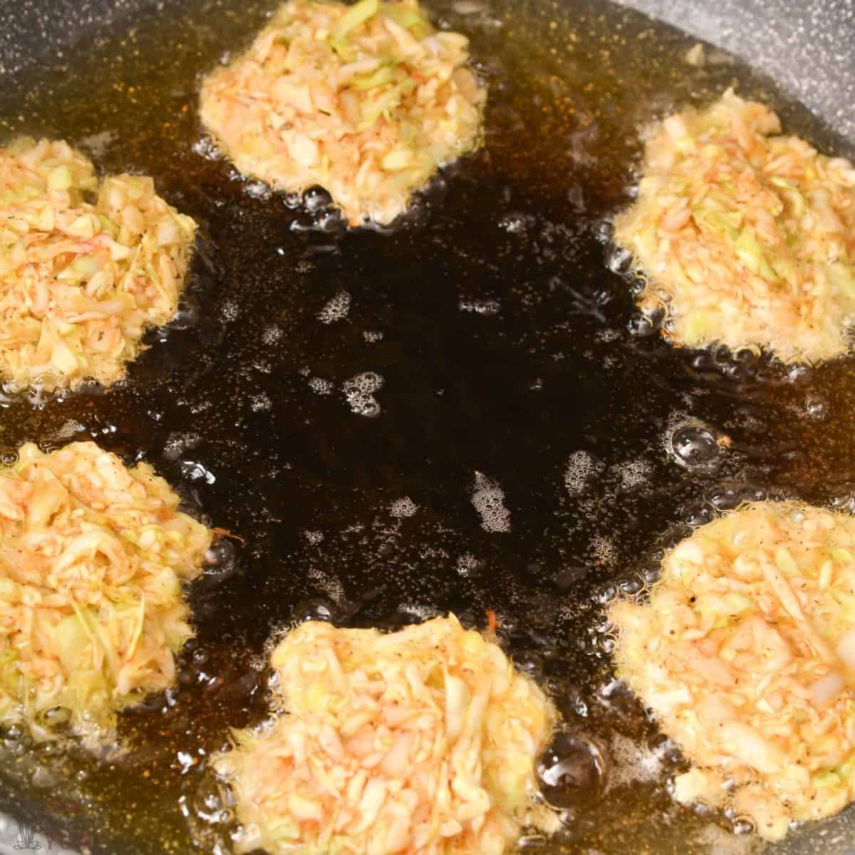 cabbage hash browns cooking in hot oil.