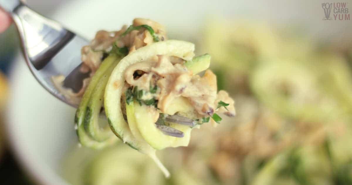 creamy white clam sauce and zoodles on fork.