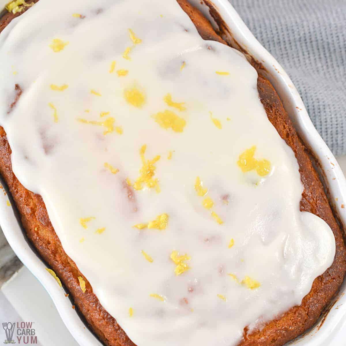 glazed spread on loaf topped with lemon zest.