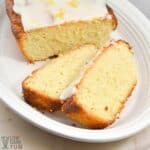 sliced lemon loaf on white platter.