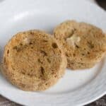 buttered low-carb english muffins on white plate.