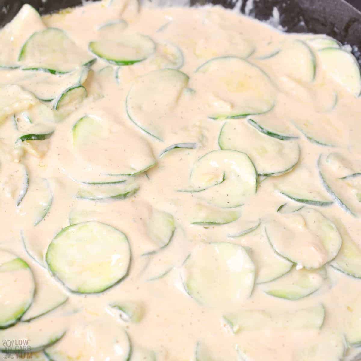 cream sauce poured over cooked zucchini slices.