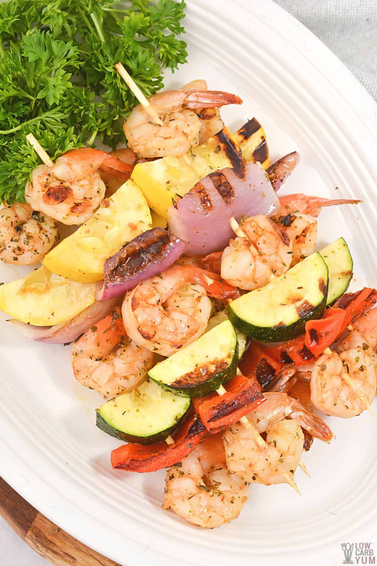 shrimp kebobs on white platter.