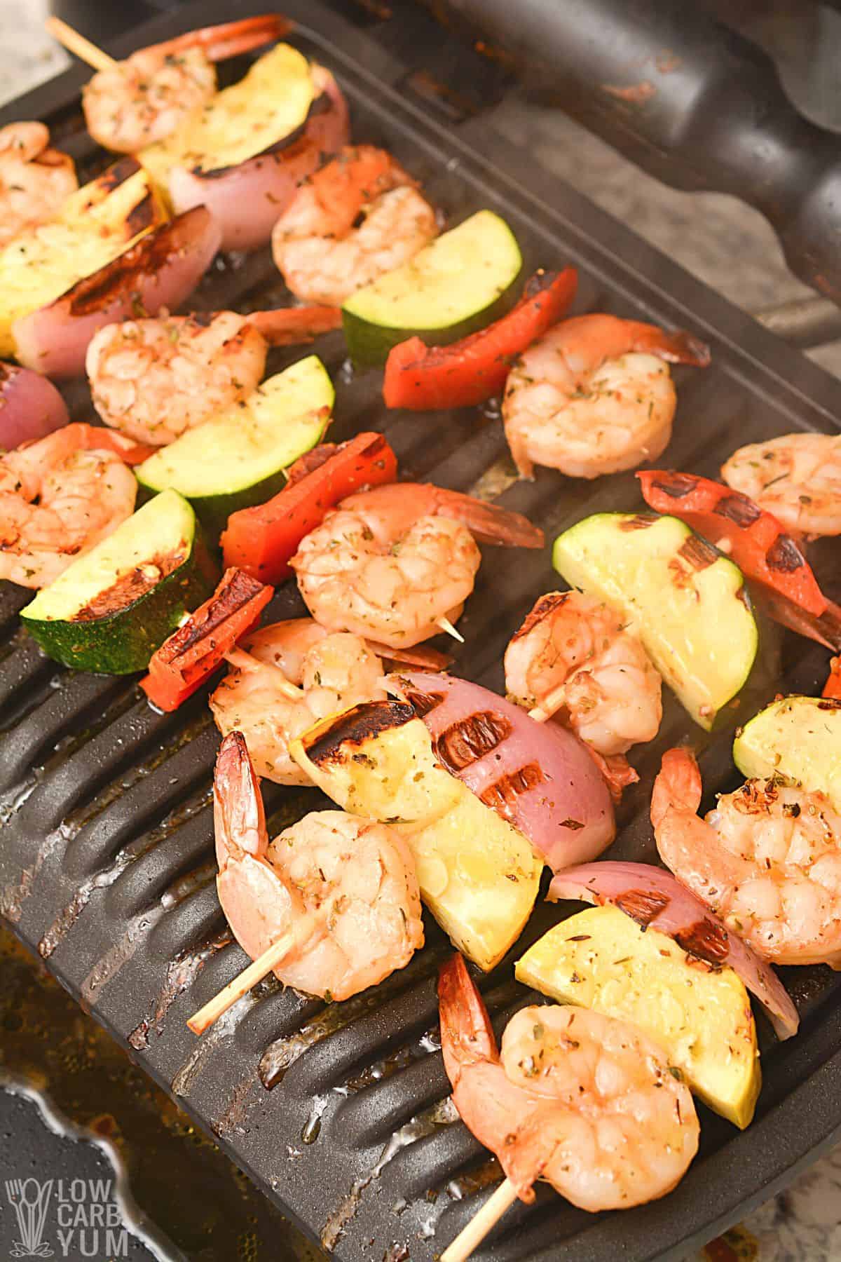 grilling the skewered shrimp and vegetables.