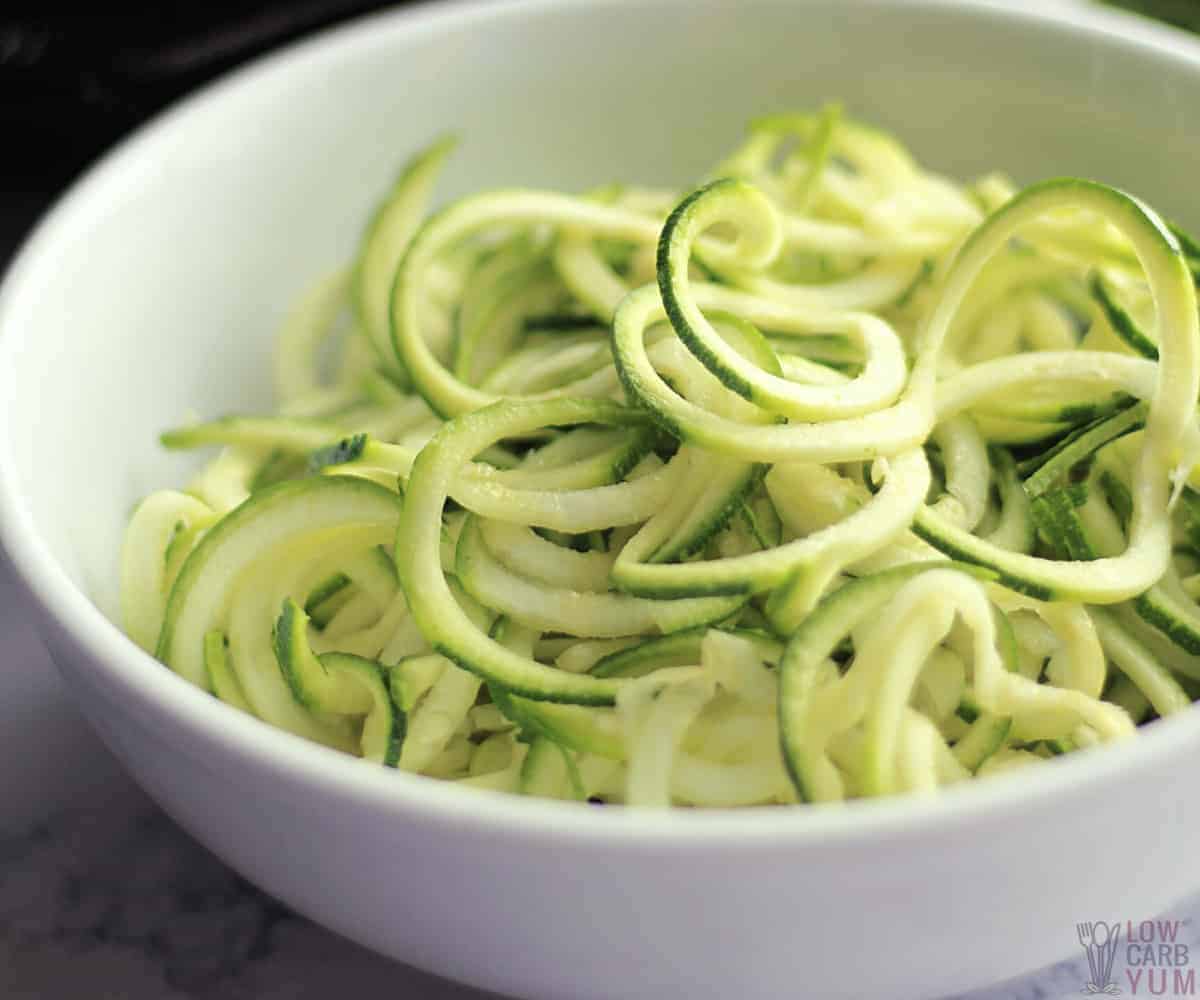 spiralized zucchini in white bowl.