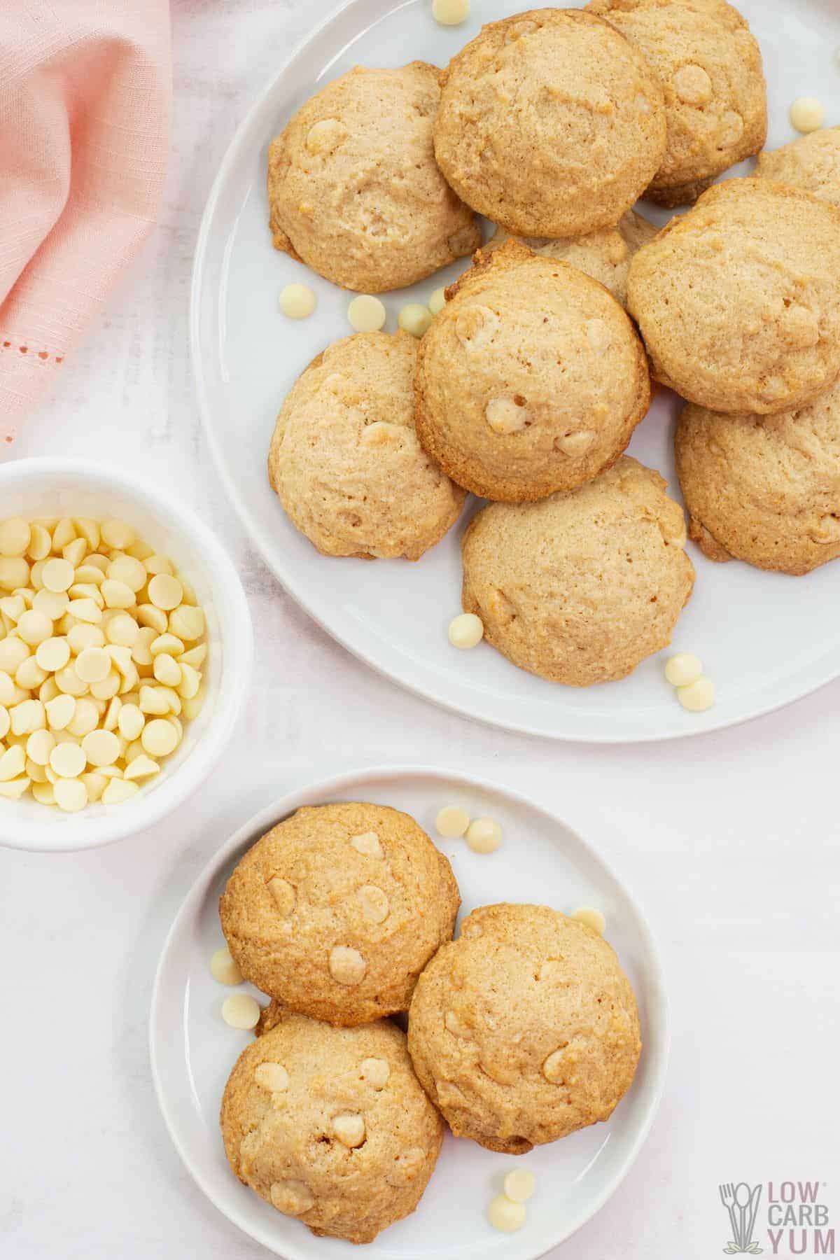 white chocolate hazelnut cookies on white plates with baking chips.