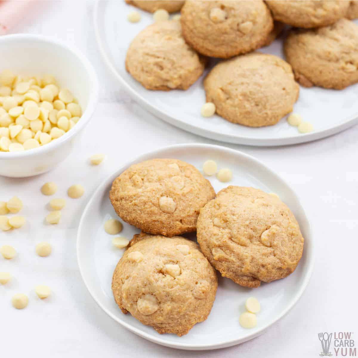 white chocolate hazelnut cookies on white plates with baking chips.