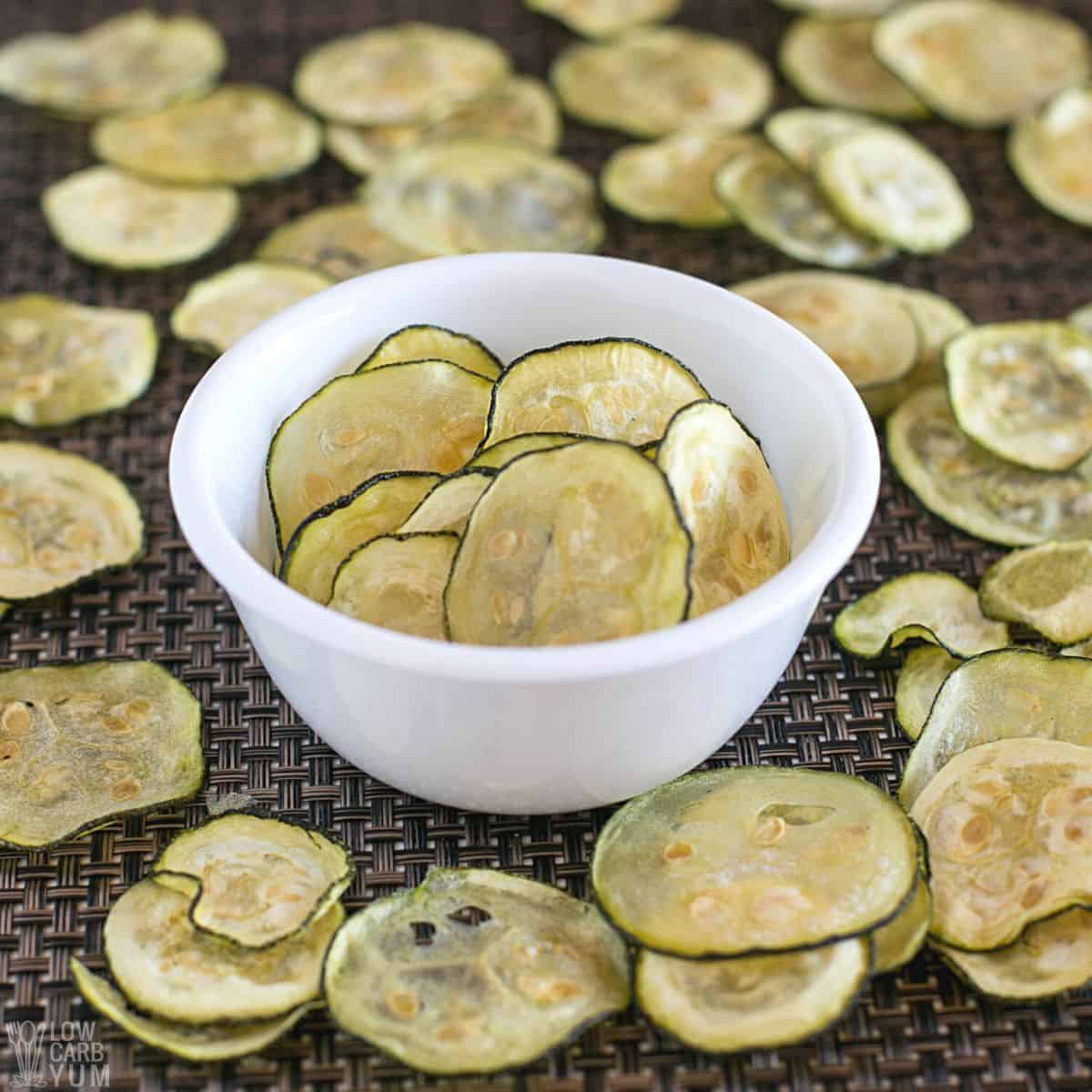 baked zucchini chips in small white bowl.