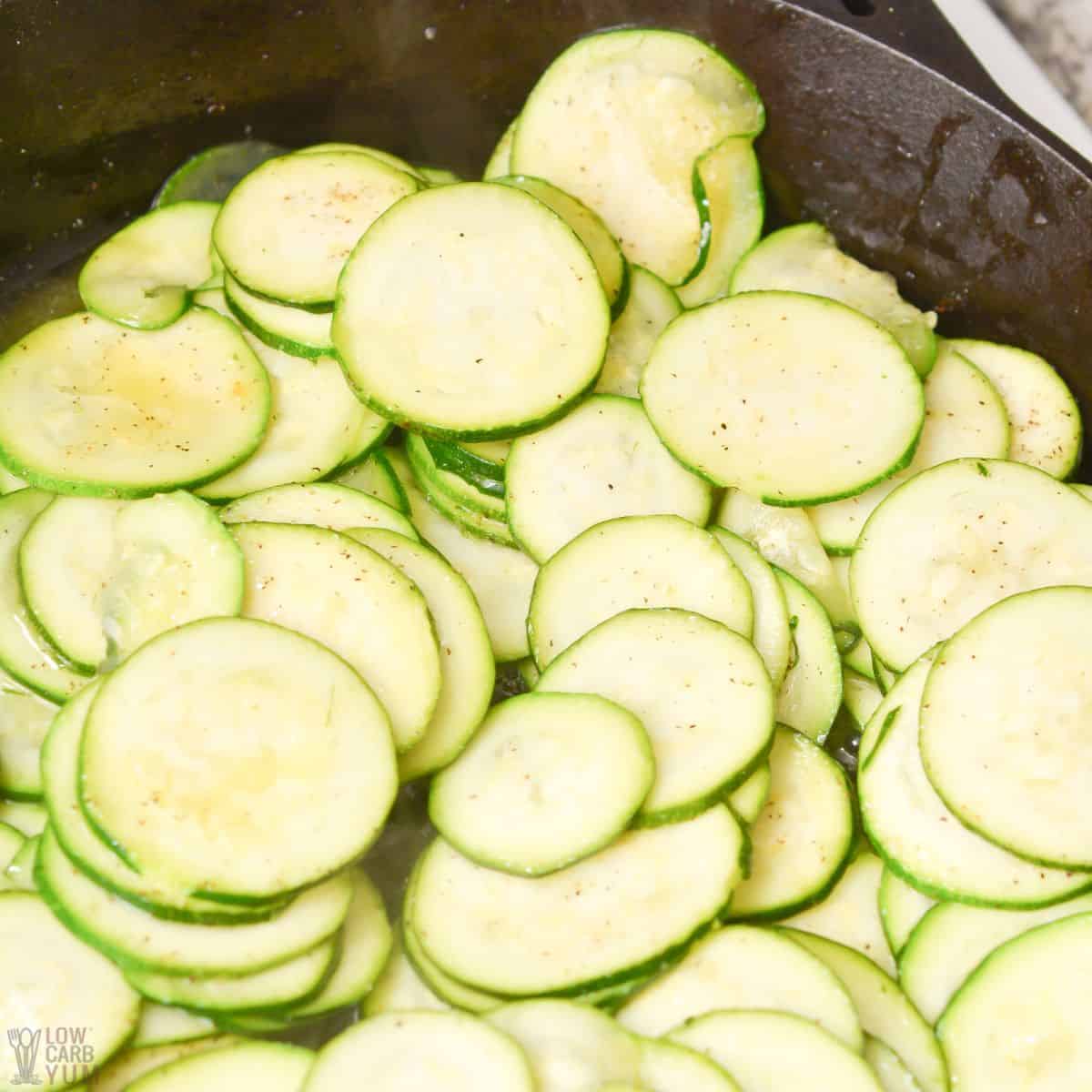 zucchini slices in cast iron skillet.