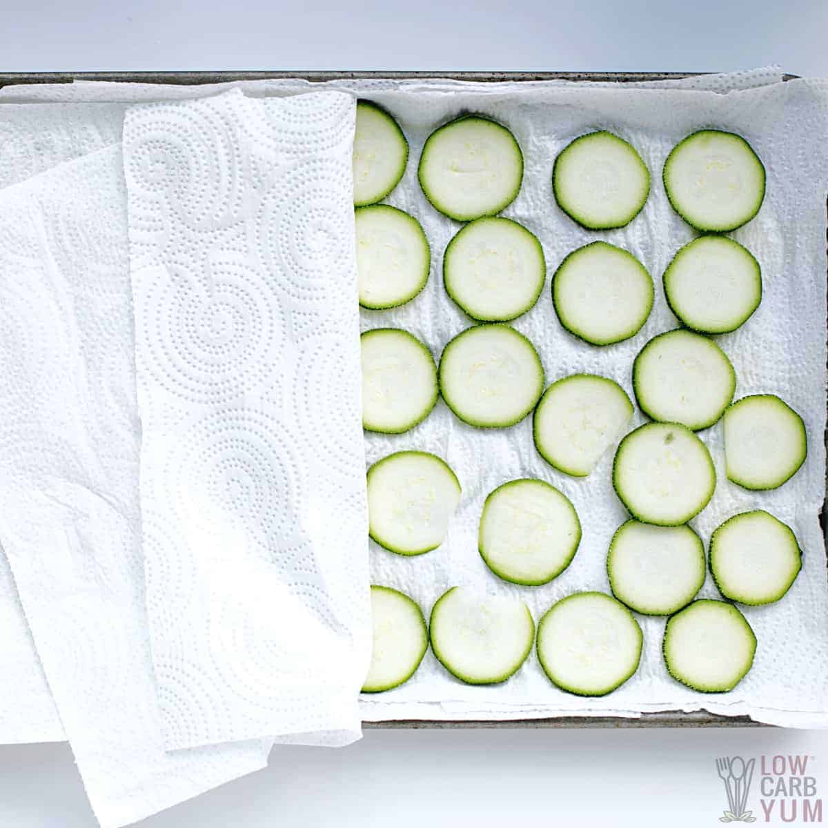 zucchini slices between paper towel layers.
