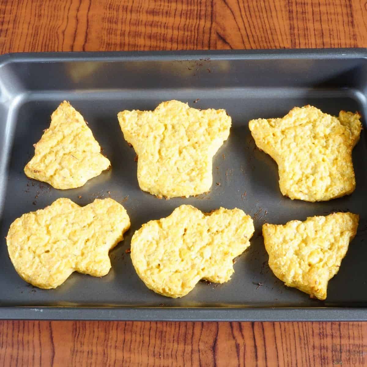 baked cauliflower crusts on baking pan.