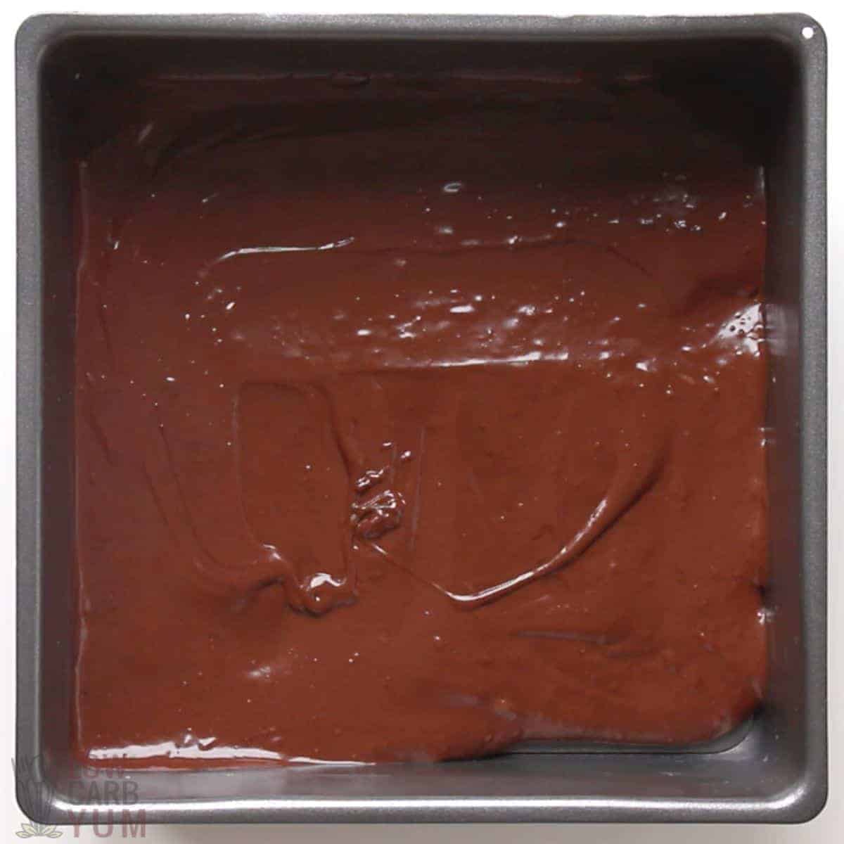 brownie batter in square baking pan.