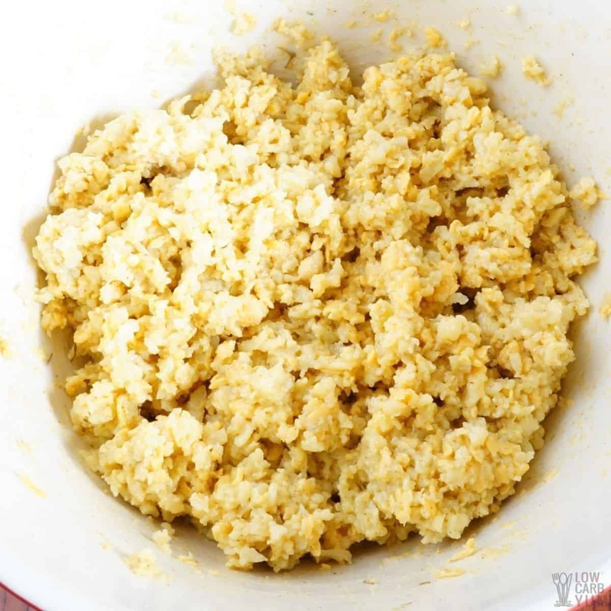 cauliflower crust mixture in white mixing bowl.