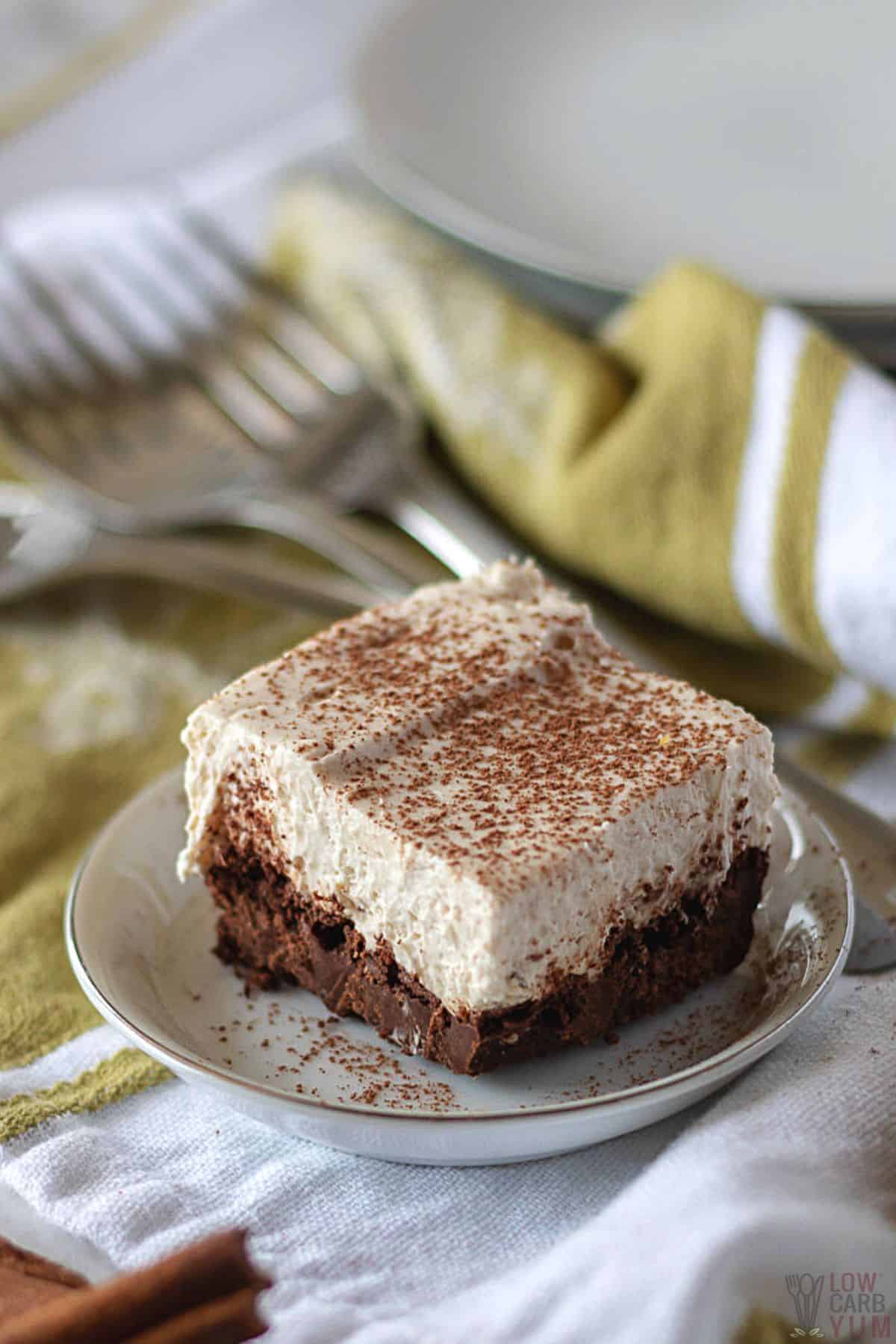 cheesecake brownie with cocoa garnish.