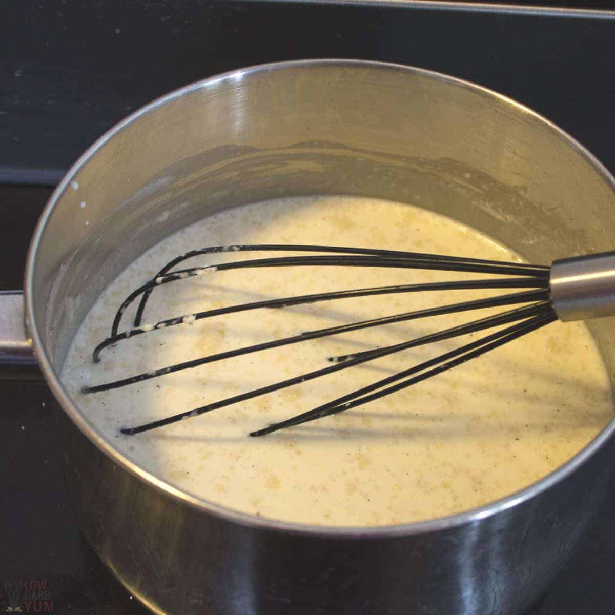 whisking the milk and cream mixture in saucepan.