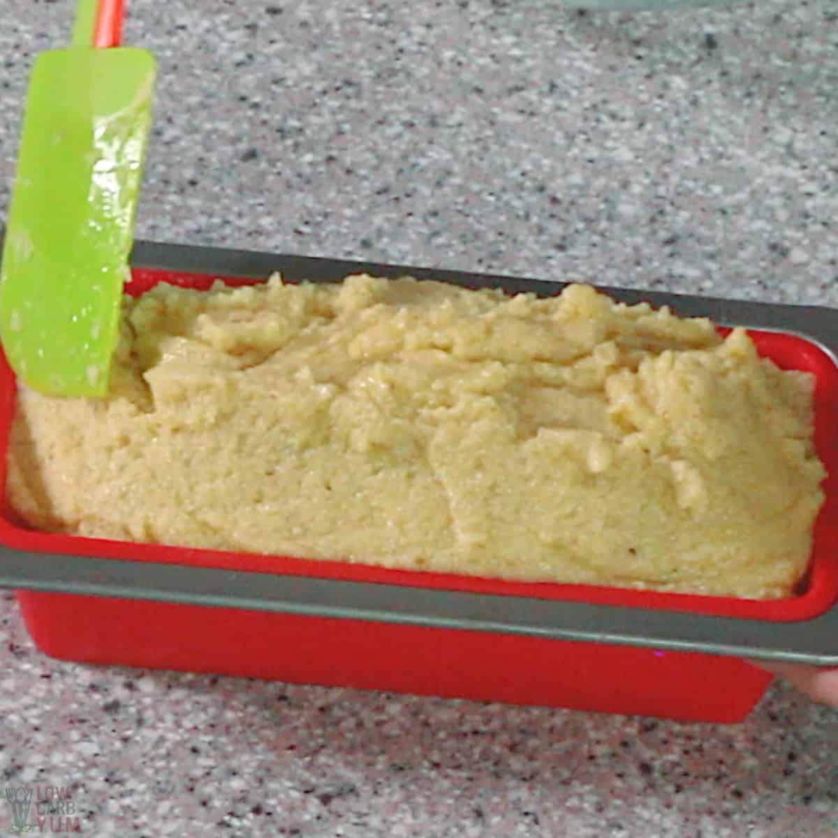 keto bread batter in red silicone loaf pan.