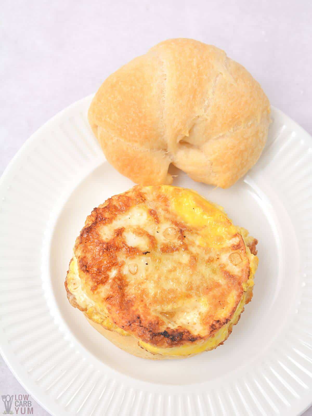 cooked egg ring on croissant roll.