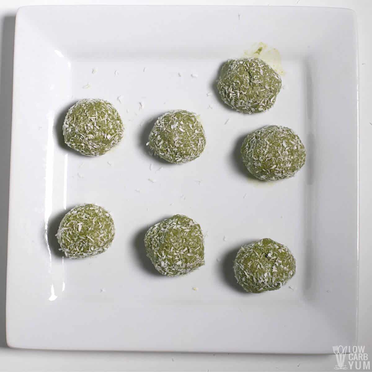 matcha keto protein balls on white square plate.