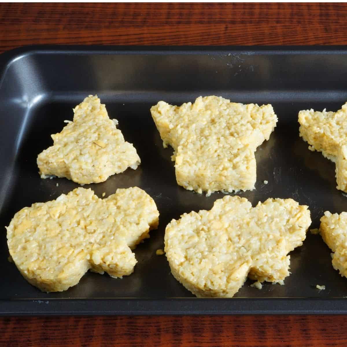 shaped cauliflower crusts on baking pan.