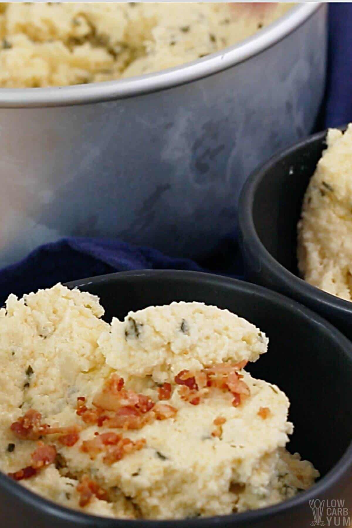 cauliflower souffle in dark bowl with pot.