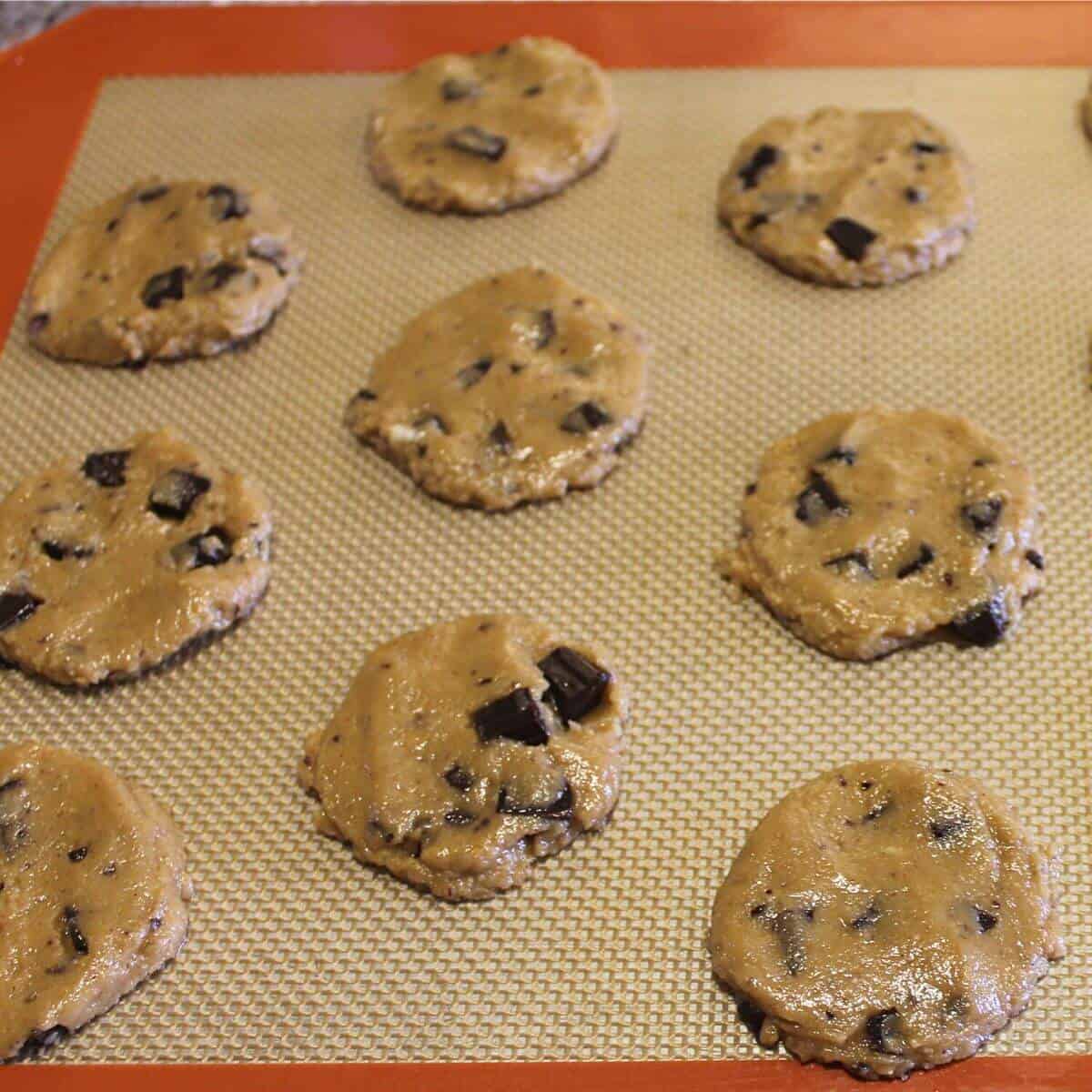 cookie dough circles on lined pan.