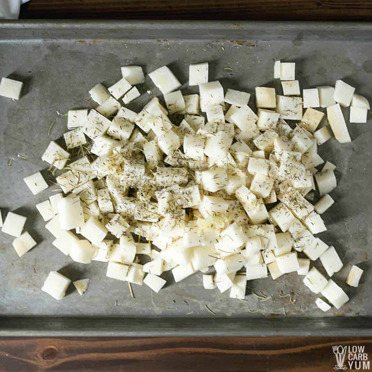 seasoned jicama cubes on baking sheet.