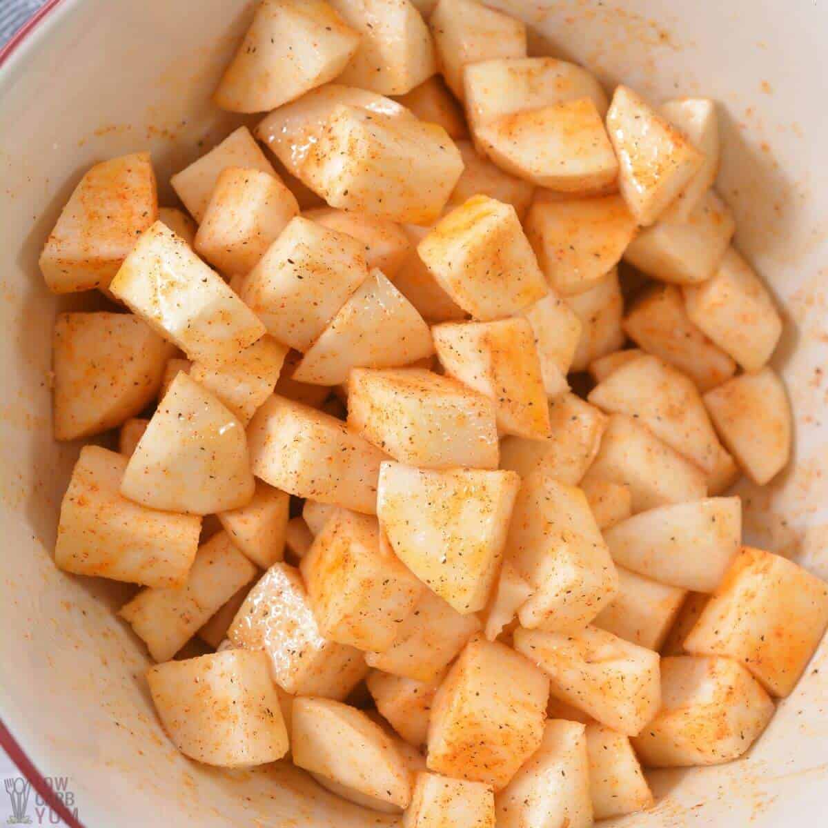 seasoned turnip cubes in mixing bowl.