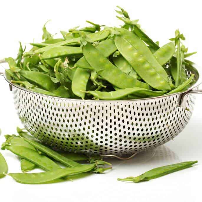 snow peas in colander.