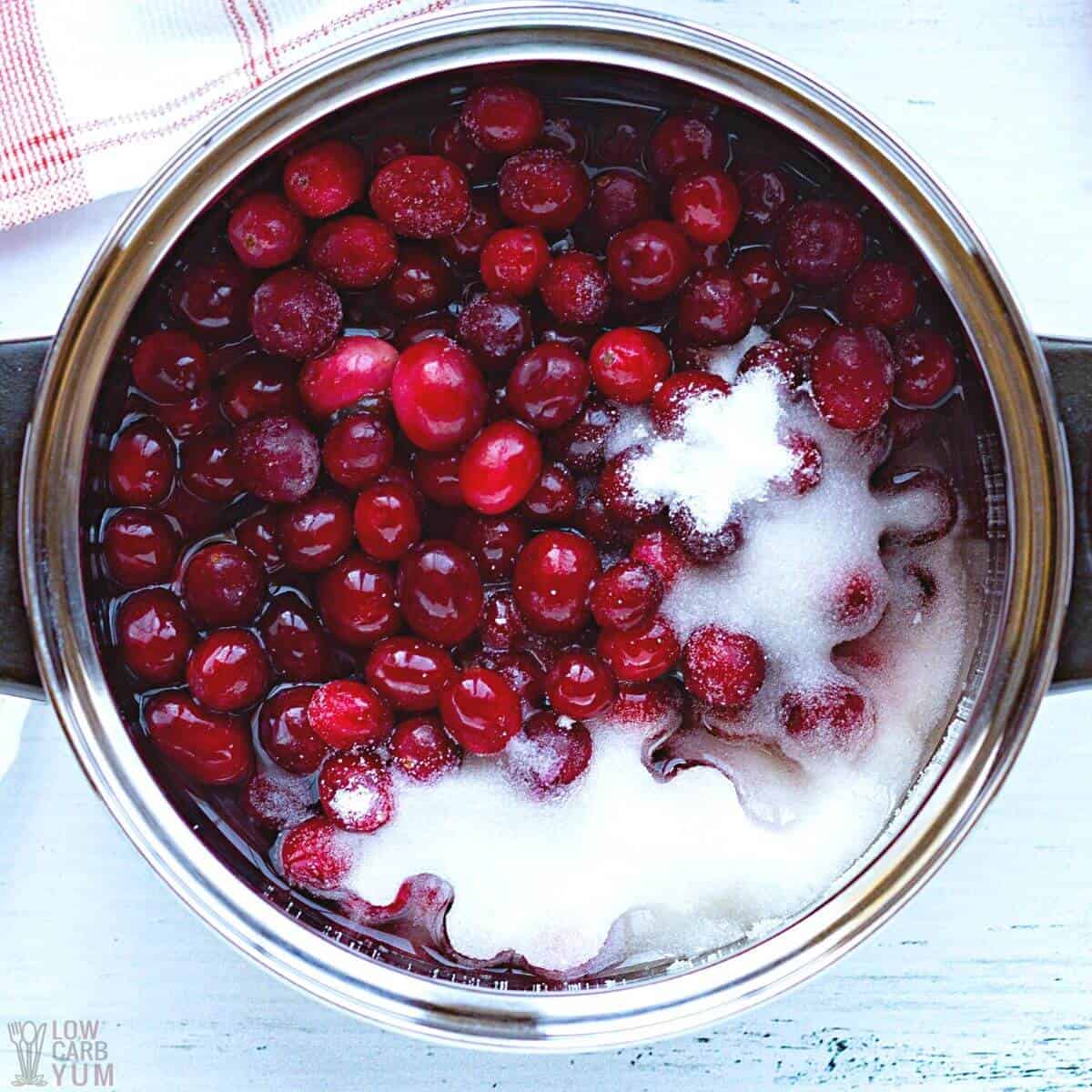 water and sweetener added to cranberries in pot.