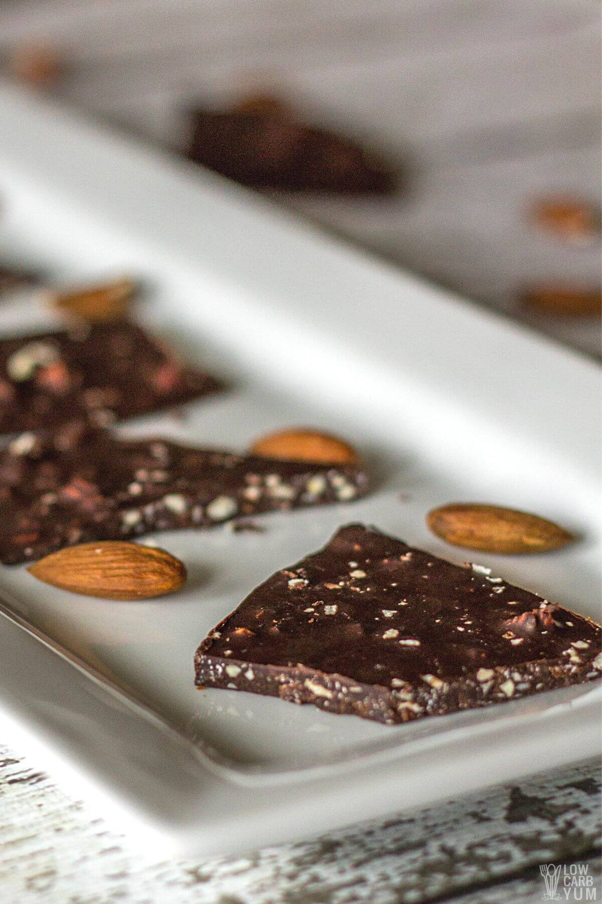 dark chocolate almond bark on white platter.