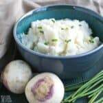mashed turnips in green bowl.