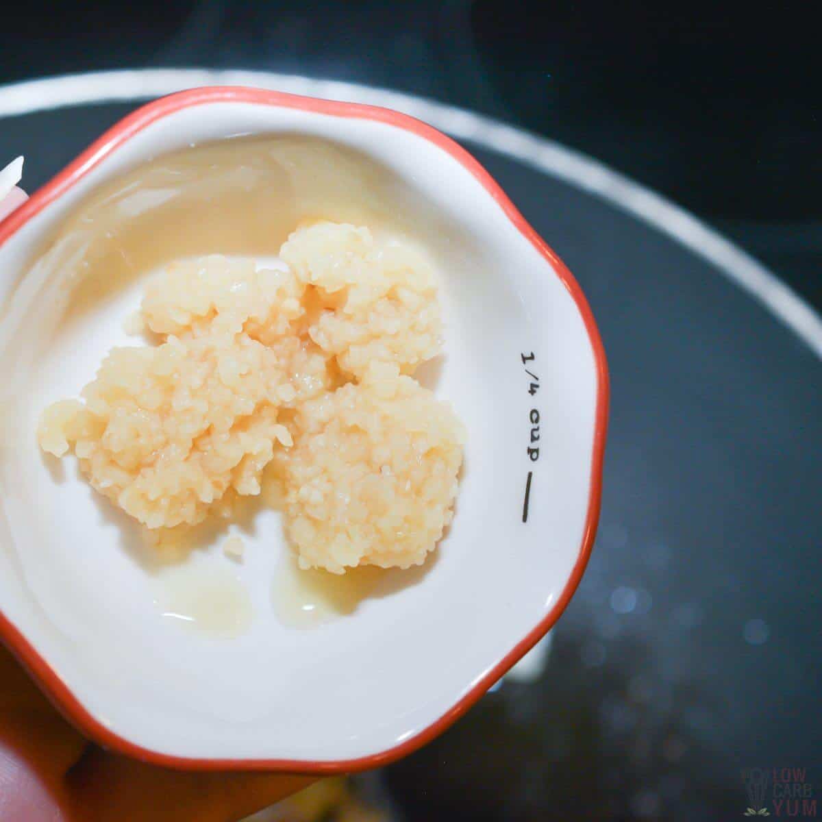 adding minced garlic to pan.